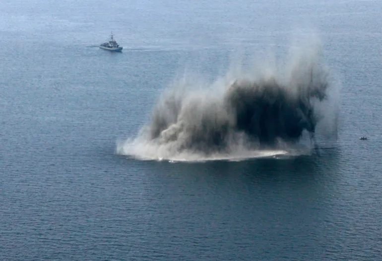 Navy ships guard while sea mine is destroyed at Irben Strait in Baltic sea